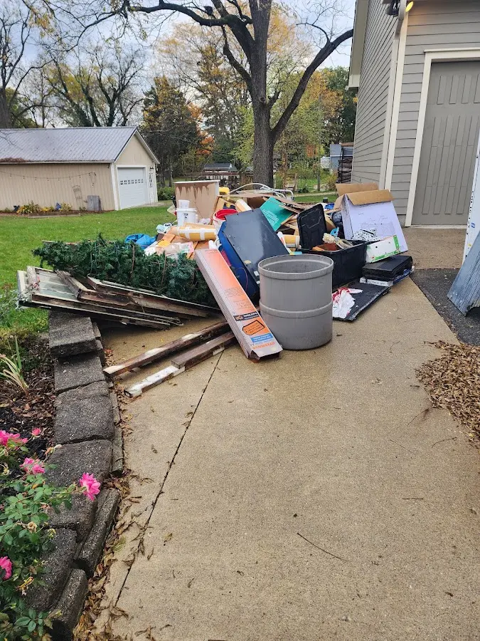 Dumpster being loaded with debris for 30 Yard Dumpster Rental in Magee